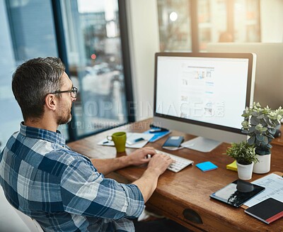 Buy stock photo Cropped shot of a businessman working on his computer in the office