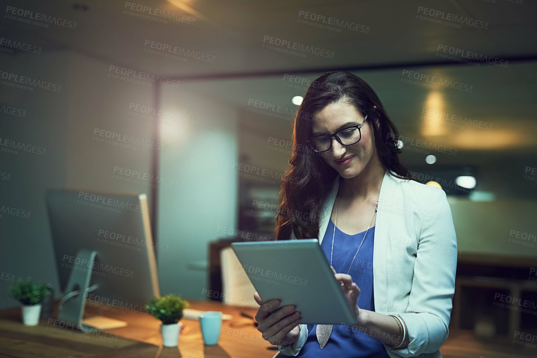 Buy stock photo Smile, night and business woman with tablet in office for planning, schedule or researching project. Professional, digital developer and employee with tech for networking, website review or online