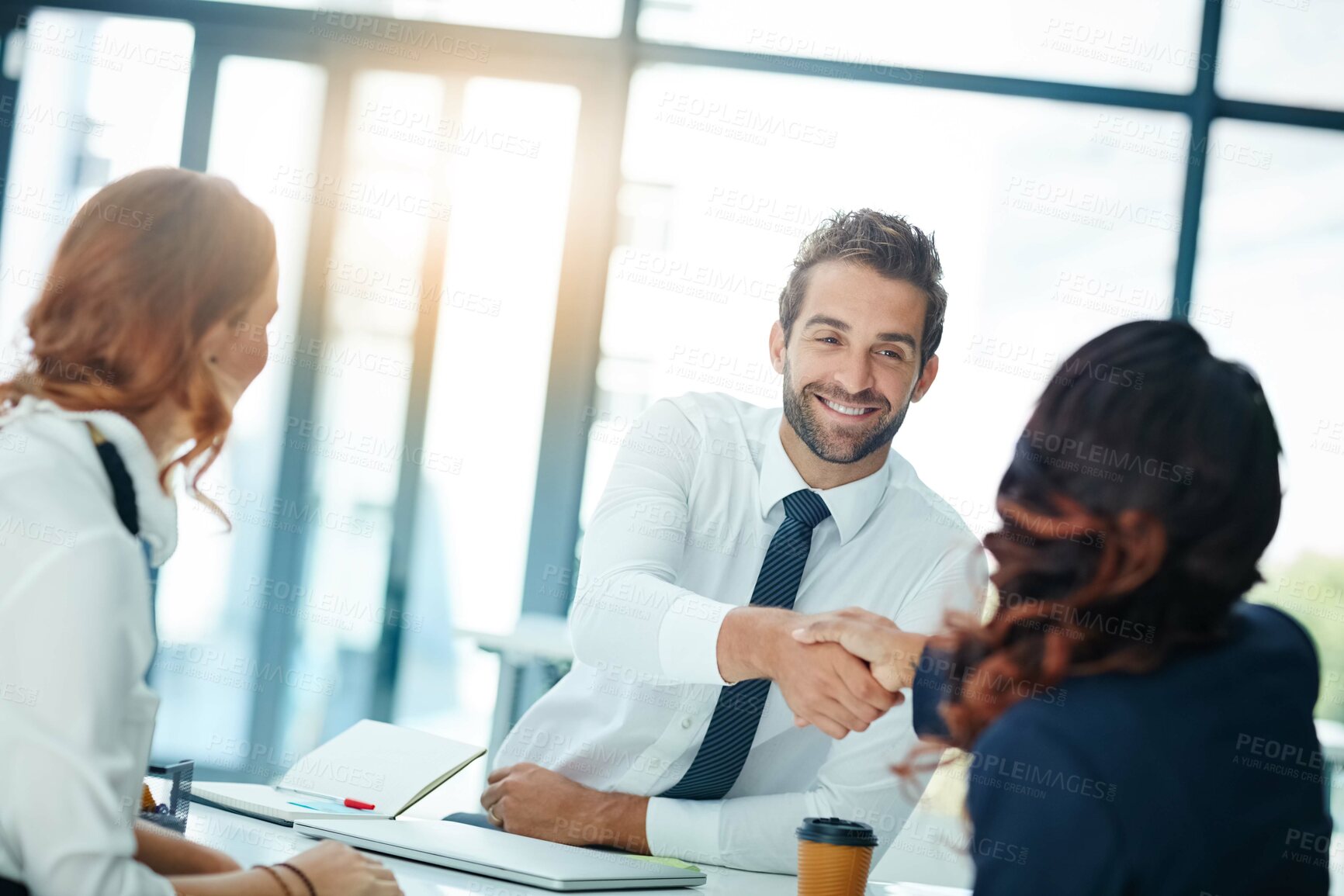 Buy stock photo Cropped shot of businesspeople shaking hands in an office