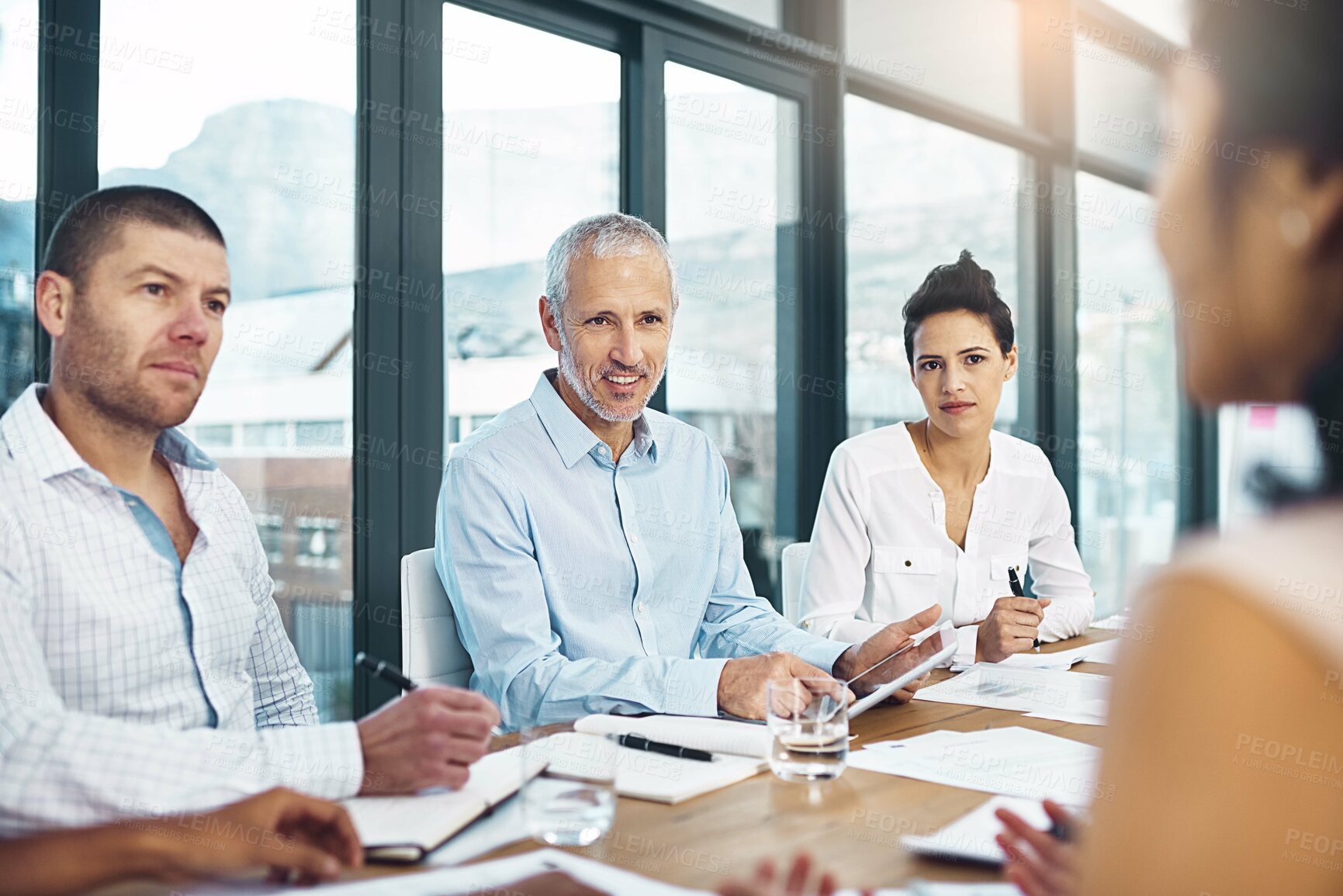 Buy stock photo Creative, business people and team discussion in meeting, planning or brainstorming startup ideas with mature manager. Designer, group or collaboration on strategy, conversation and writing notes