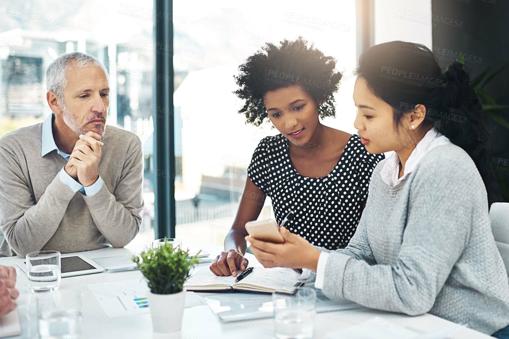 Buy stock photo Business people, meeting and smartphone in office for planning, discussion and teamwork with technology. Coworkers, notes and mobile in boardroom for project, ideas and brainstorming at workplace