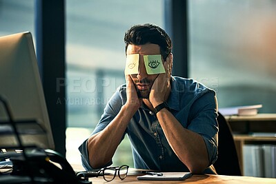 Buy stock photo Shot of a tired young businessman working late in an office with adhesive notes covering his eyes