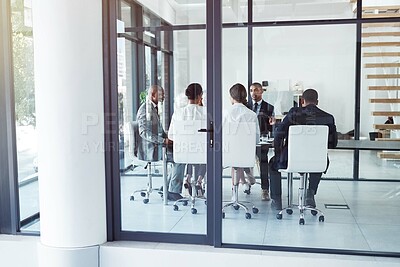 Buy stock photo Shot of a young businessman experiencing stress during a late night at work