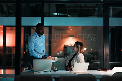 Buy stock photo Handshake, talking and agreement by laptop in office, night and listening for financial advice. Man, woman and teamwork for review deadline or deal with project partnership, dark or decision