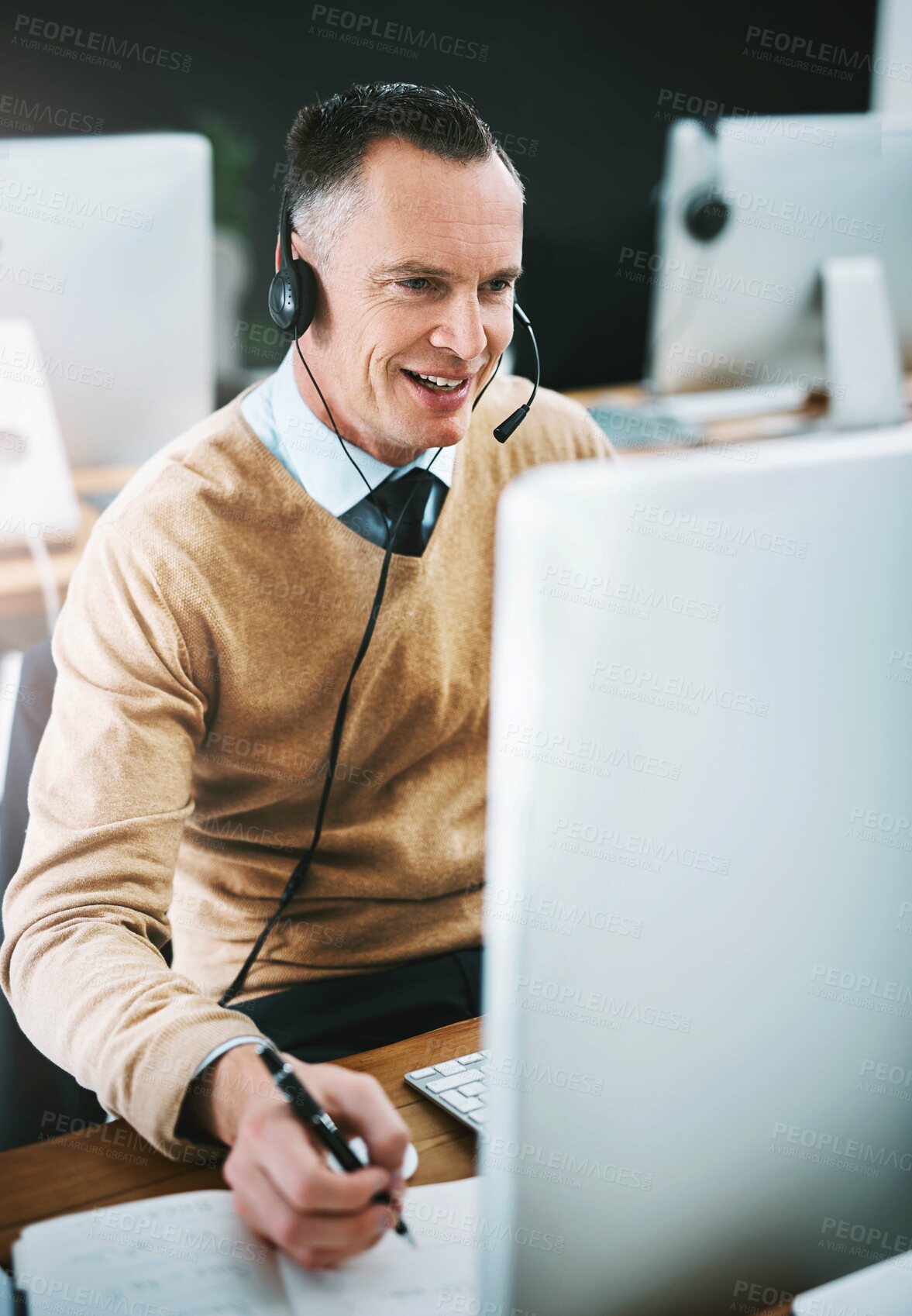 Buy stock photo Phone call, notes and man at computer in customer support, help desk or telemarketing office. Headset, online consultation and callcenter agent with smile for lead generation, advice or telecom sales