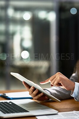 Buy stock photo Cropped shot of a businesswoman using a digital tablet and laptop at her desk in a modern office