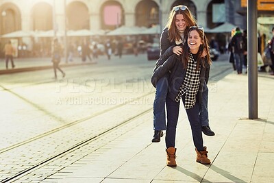 Buy stock photo Friends, piggyback and outdoor portrait in city, bonding and travel to Berlin on weekend trip. People, together and games on vacation in urban town, laughing and love in sisterhood or relationship
