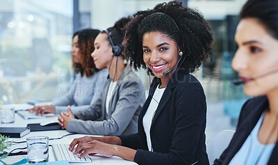 Buy stock photo Portrait of a young woman working in a call centre alongside her colleagues