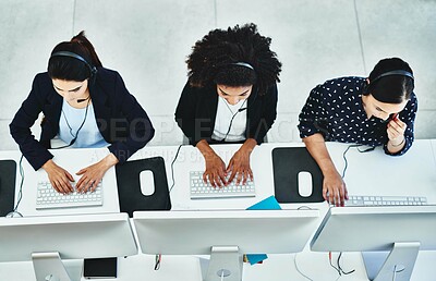 Buy stock photo High angle shot of a group of women working in a call centre