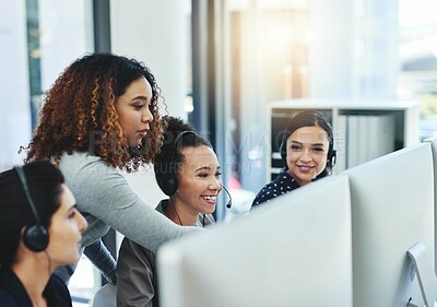 Buy stock photo Shot of a young woman assisting her colleagues in a call centre