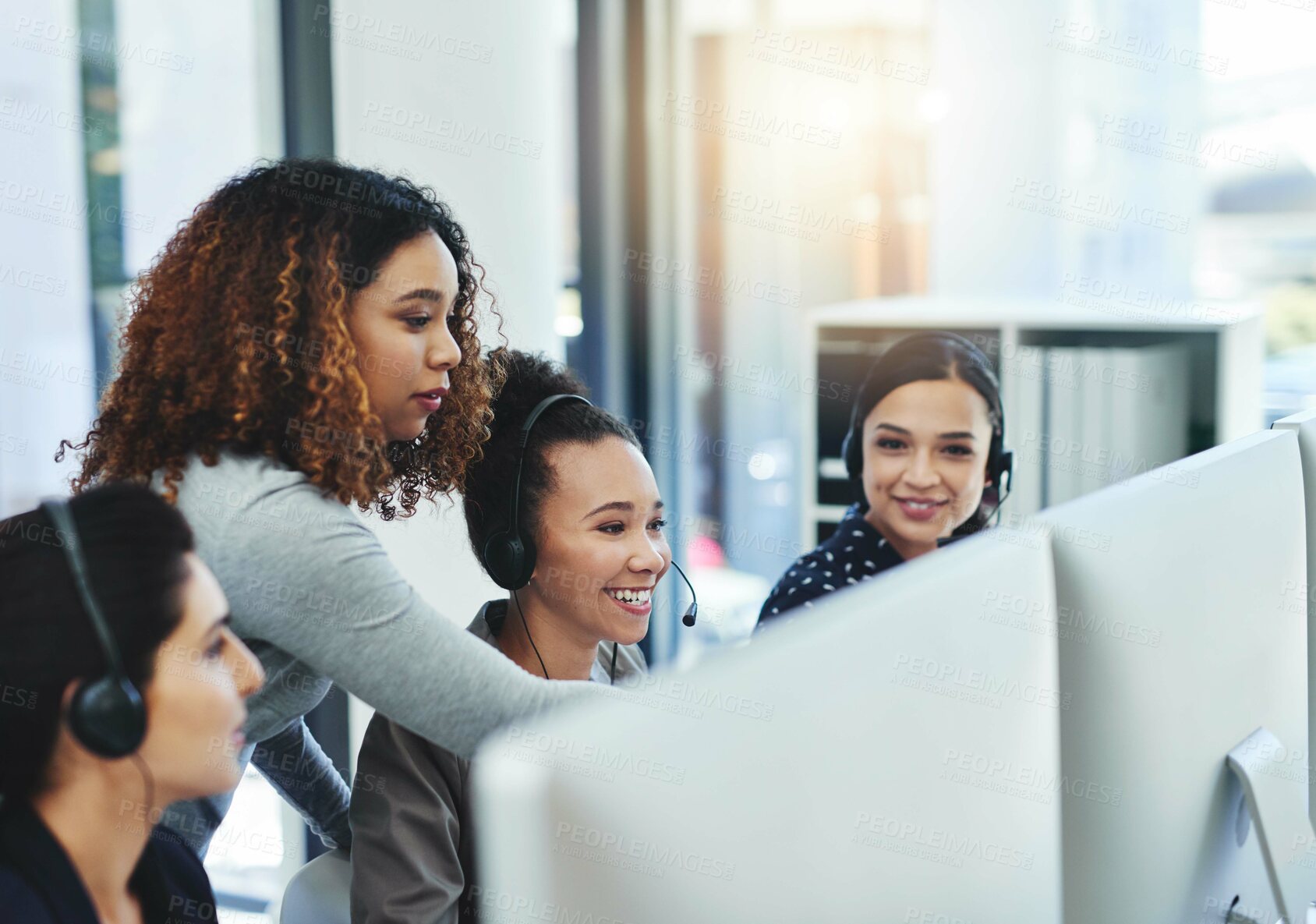 Buy stock photo Shot of a young woman assisting her colleagues in a call centre