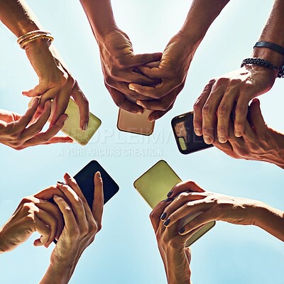 Buy stock photo Low angle, smartphone and hands with people, huddle and communication or connectivity. Friends, social media and information sharing with diverse, group and standing in circle outdoors in nature park