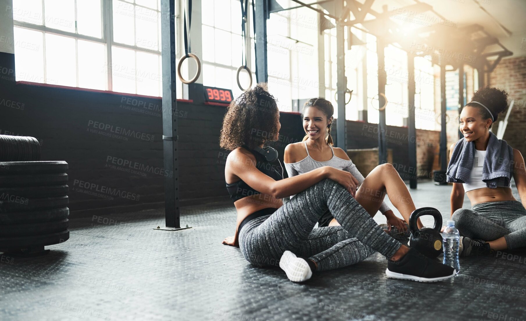 Buy stock photo Conversation, gym and women on floor, relax  and goals with fitness, gossip and exercise. Happy people, friends and wellness facility for training, resting and discussion for progress and support