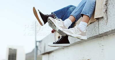 Buy stock photo Shoes, legs and couple on rooftop in the city sitting together, having fun or bonding. Fashion sneakers, roof and man and woman kick feet on building, enjoy weekend or freedom in urban town outdoor