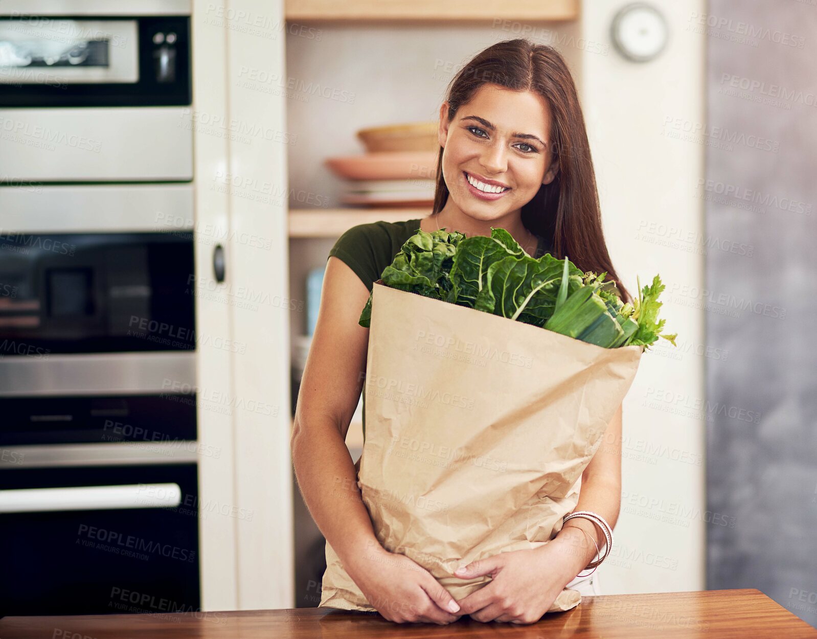 Buy stock photo Woman, portrait and bag with vegetables in kitchen for grocery shopping, healthy food and spinach. Person, face and happy with cooking ingredients for nutrition, organic meal or fresh produce in home