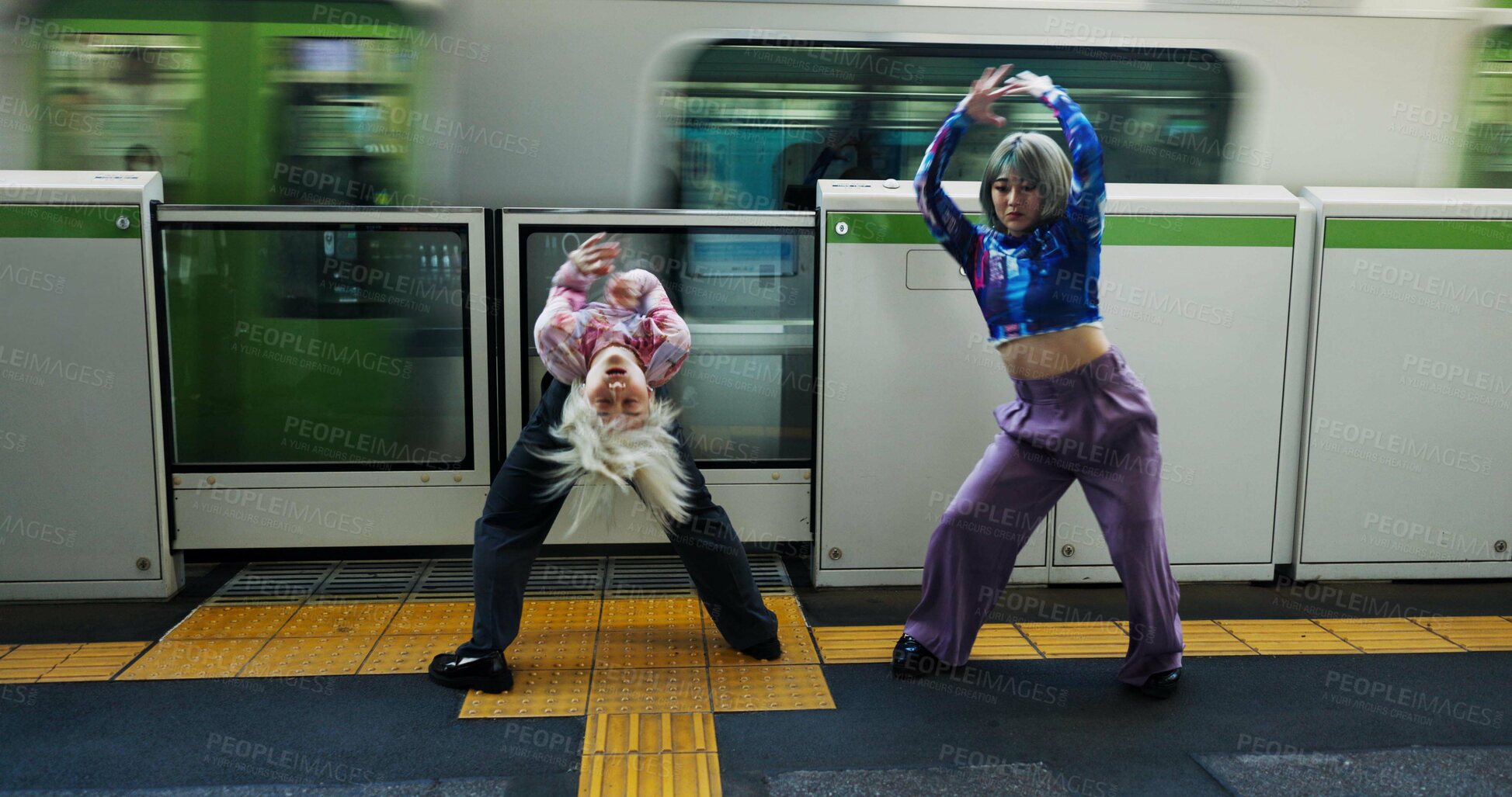 Buy stock photo Asian woman, dancing and railway station by train for energy, art or underground performance in subway. Female person, friends or hip hop dancers in Japan, practice or training together by transport
