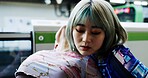 Japanese women, friends hug and city by train station with care, kindness and bonding on vacation. Girl, embrace and love in metro for transportation, travel or gen z fashion with streetwear in Tokyo
