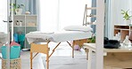 Therapy room, empty and a bed for physiotherapy, hospital exam or healthcare test. Clinic bedroom, medicine and gear and tools in an chiropractic or orthopedic office for a consultation or check