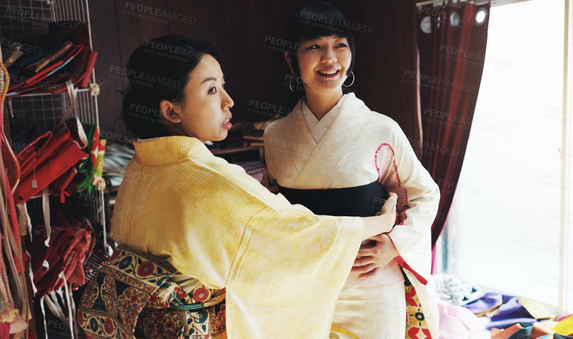 Buy stock photo Asian woman, tailor and size with garment for kimono, style or dress making at boutique. Japan, female person or fashion designer with customer, fabric or waist belt for clothing design at store