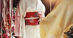 Hands, woman and size to tailor waist for fashion, dress maker and kimono fitting in boutique. People, designer and style clothing for culture tradition in Japan, fabric check and closeup of helping 