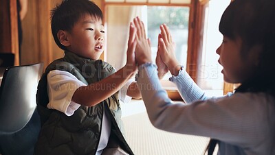 Buy stock photo Home, children and playing clapping game for bonding, cognitive development and coordination. Japanese people, kids and fun activity in living room for learning, interaction and motor skills on floor