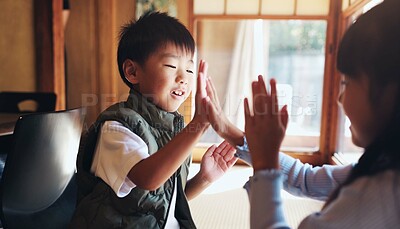 Buy stock photo Family, children and playing clapping game for bonding, cognitive development or coordination. Japanese people, kids or fun activity in living room for learning, interaction and motor skills on floor