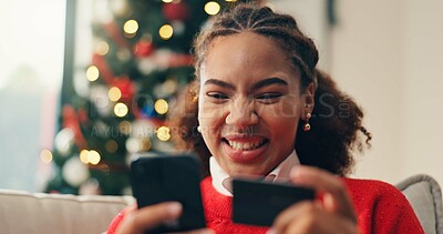 Buy stock photo Christmas, credit card and phone with black woman in living room of home for online shopping. App, ecommerce and payment checkout with happy person in apartment to purchase gift or present on mobile