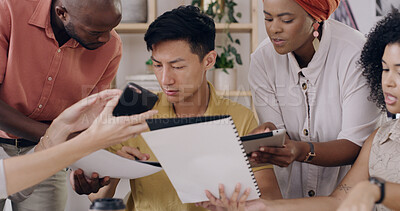 Buy stock photo Man, chaos and overwhelmed with multitasking at startup with team, phone and documents at media company. Person, group and crisis management with deadline, overtime and review at creative agency