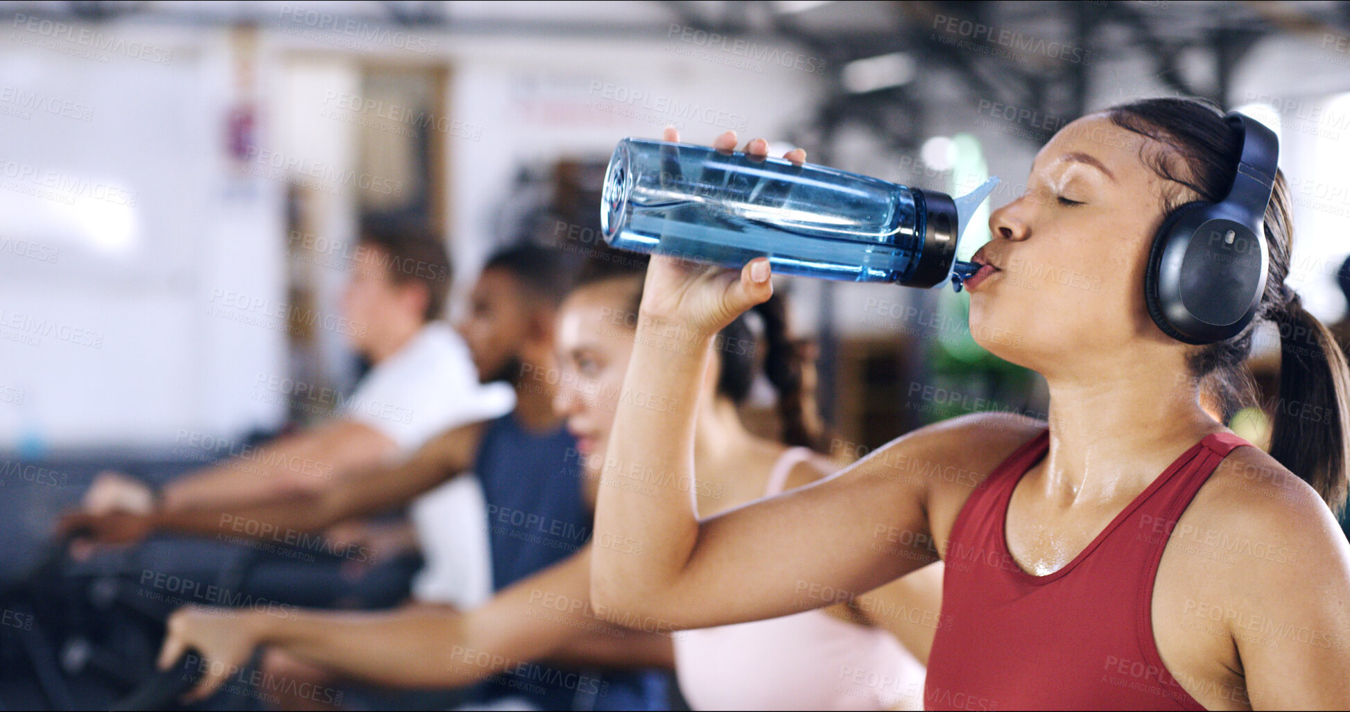 Buy stock photo Drinking water, fitness and woman in gym, hydration and headphones with challenge. Mineral liquid, thirsty and health person in center, exercise and workout with cold beverage, sound and podcast