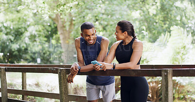 Buy stock photo Bridge, smile and couple with cellphone, workout and bonding together with social media. Funny meme, outdoor and man with healthy woman, talking and smartphone with training, internet and digital app