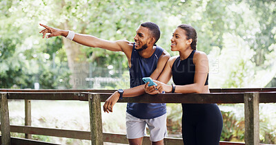 Buy stock photo Pointing, phone and runner with couple outdoor for workout partner, running target and athlete tracking. Exercise app, route discussion and training landmark with man and woman on bridge for fitness