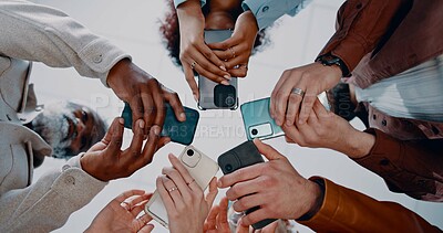 Buy stock photo Business people, hands and below with phone in circle for data sync, share or communication in office. Low angle, group or employees with mobile smartphone for networking or connectivity together