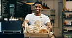 Black man, portrait and small business with bread in bakery for food, breakfast or wheat. Male person, pastry chef or baker with smile or basket of loafs or rolls in cafe for hospitality service