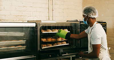 Buy stock photo Bread, cafe and oven with man in kitchen for cooking, culinary process and food production. Bakery, wheat and baking with person in coffee shop for catering, restaurant and small business owner