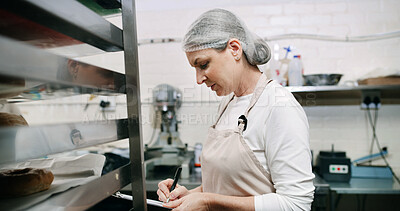 Buy stock photo Baker, woman and writing on document in kitchen for supplies, stock or order. Pastry chef, clipboard or mature person in bakery for inventory notes, checklist or schedule with information in business