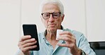 Medicine, pills and phone with old man in home for dosage instruction, reading and side effects. Research, online pharmacy and medical information with senior person in apartment for prescription