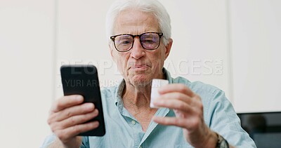 Buy stock photo Medicine, pills and phone with old man in home for dosage instruction, reading and side effects. Research, online pharmacy and medical information with senior person in apartment for prescription