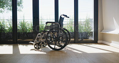 Buy stock photo Healthcare, empty nursing home and wheelchair for support, mobility aid and injury rehabilitation. House, chair and equipment for disability, transportation and recovery with medical care by window
