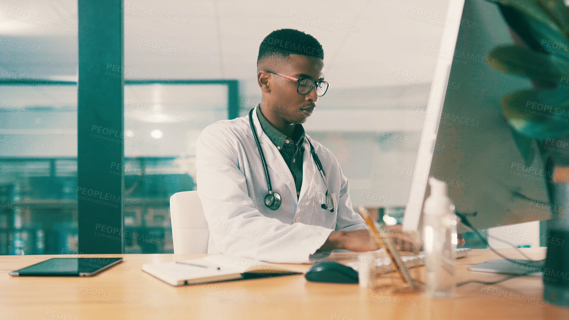 Buy stock photo Computer, notebook and typing with doctor black man at hospital desk for results report. Healthcare, medical and online research with medicine professional in office at clinic for agenda or schedule