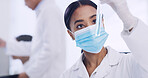 Science, woman and scientist with vial in laboratory with mask for medical research, discovery or study. Chemical liquid, test tube and female biochemist with pharmaceutical solution for healthcare.