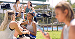 Break, conversation and drinking water with girls on hockey pitch together for fitness or training. Exercise, hygiene and sports with teen friends on grass field bonding, practice or workout