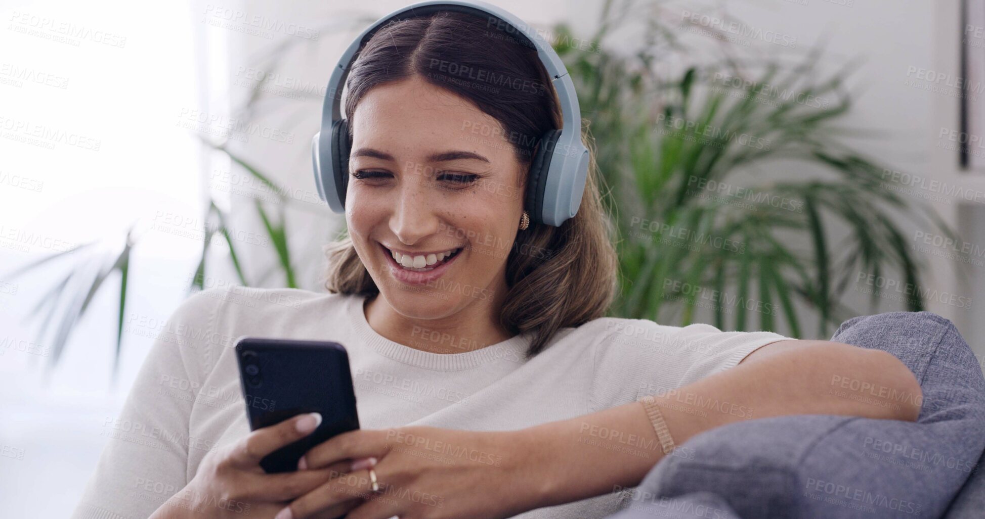 Buy stock photo Phone, relax and happy woman with headphones in home, streaming service or music on internet. Mobile, audio and person in living room for playlist search, online sound and listening to podcast