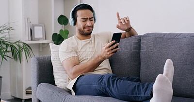 Buy stock photo Happy, phone and music with man on sofa for streaming, radio station and audio playlist. Podcast subscription, headphones and media platform with person in living room of home for connection