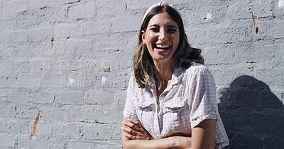 Buy stock photo Brick wall, portrait and woman laughing with arms crossed, university student and study break outside. Low angle, education and scholar outdoor for stress management, mockup space and learning pause