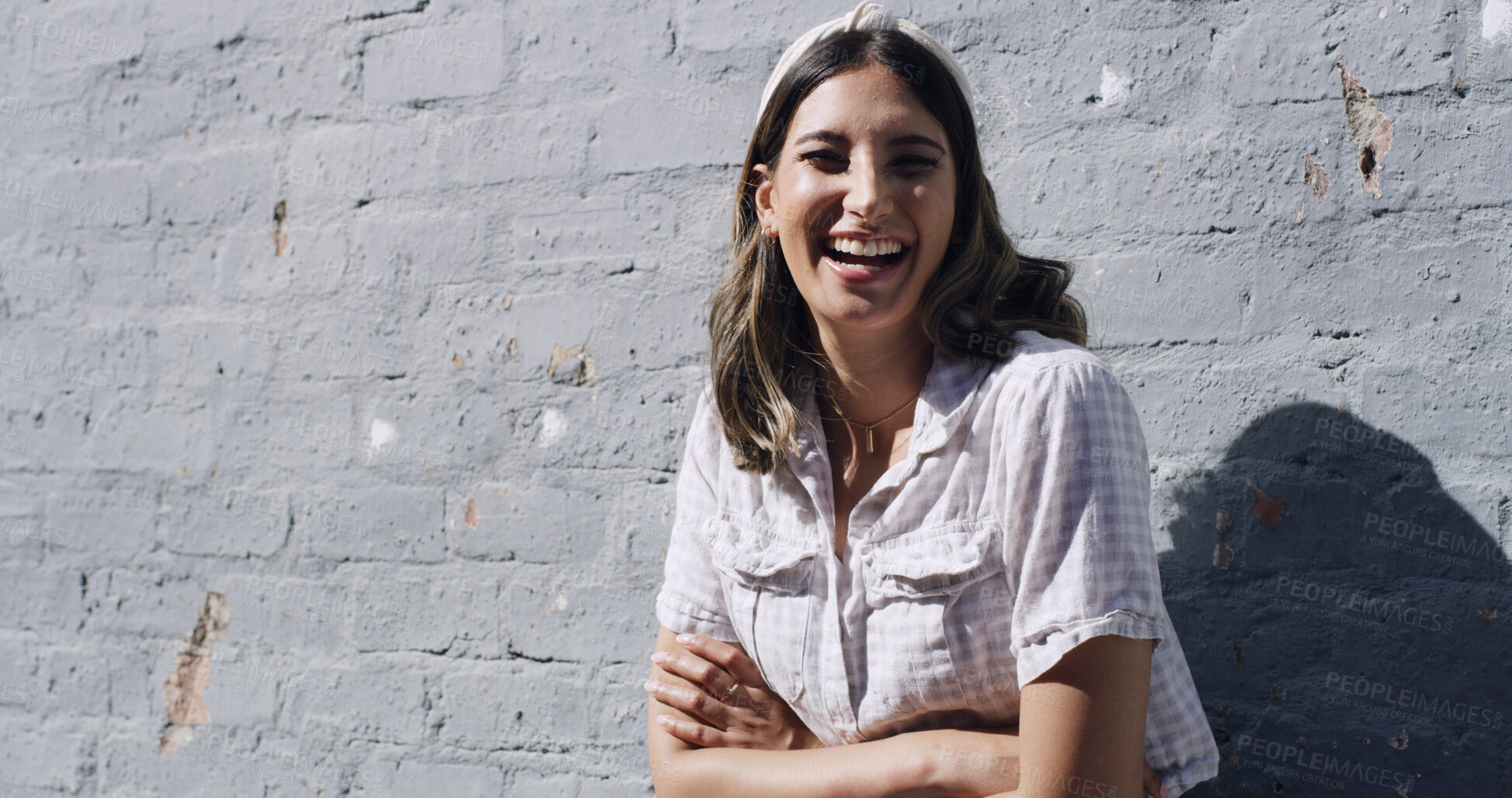 Buy stock photo Brick wall, portrait and woman laughing with arms crossed, university student and study break outside. Low angle, education and scholar outdoor for stress management, mockup space and learning pause