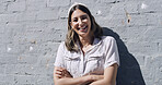 Portrait, wall and happy woman in city, arms crossed and travel with confidence, holiday and calm. Funny, outdoor and person with pride, adventure and journey with vacation, laughing and hipster