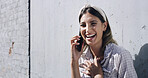Happy woman, laughing or funny joke with phone call for conversation, chat or communication in town. Female person, humor or smile with mobile smartphone for friendly discussion or comedy on wall