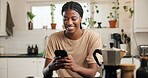 Black woman, phone and happy with texting in kitchen, contact or funny video on web at apartment. African person, smartphone and smile for notification, chat or social network with meme in house