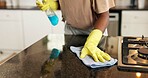 Cleaning, gloves and hands of woman in kitchen with spray bottle for hygiene, disinfection and bacteria. Housekeeping, counter and person with detergents, cloth and wipe dust for maintenance in home
