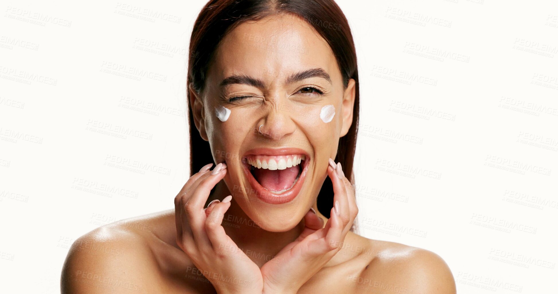 Buy stock photo Portrait, happy woman and wink in studio with lotion for skincare, wellness and collagen benefits. Space, excited person and facial cream for beauty, healthy skin and dermatology on white background.